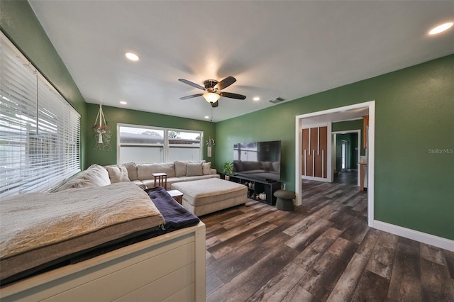 living room featuring ceiling fan and dark hardwood / wood-style flooring