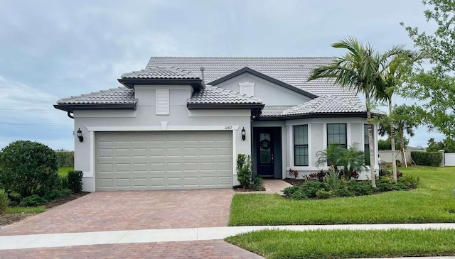 view of front of home with a garage and a front lawn