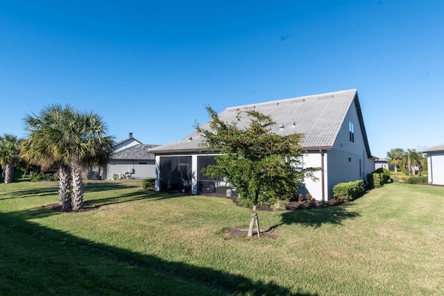 back of house featuring a sunroom and a yard