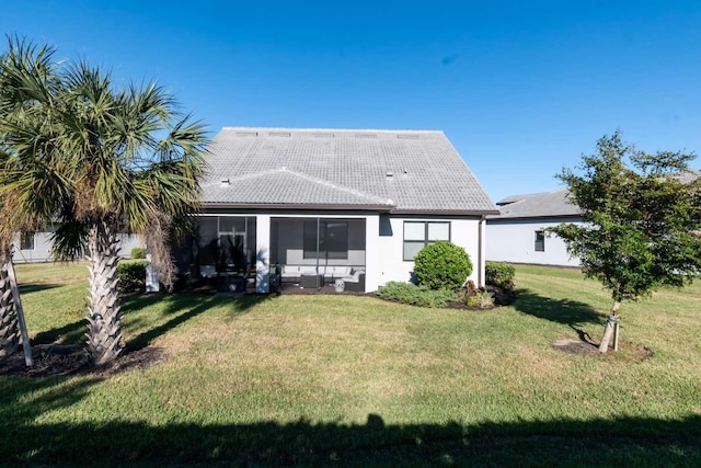 rear view of house featuring a lawn