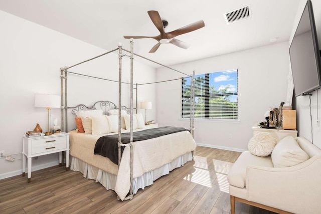 bedroom with hardwood / wood-style floors and ceiling fan