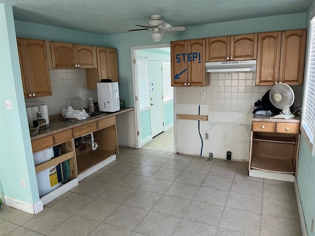 kitchen with tasteful backsplash, ceiling fan, and light tile patterned flooring