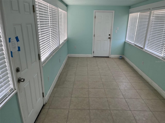 entrance foyer with plenty of natural light and light tile patterned floors