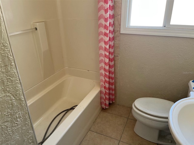 full bathroom with tile patterned flooring, shower / bath combination with curtain, toilet, and sink