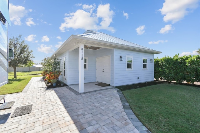 rear view of house with a yard and a patio