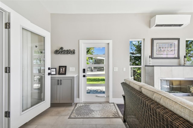 doorway featuring a wall mounted AC and light tile patterned floors