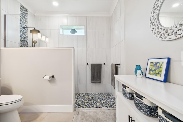 bathroom with vanity, crown molding, a shower, tile patterned flooring, and toilet