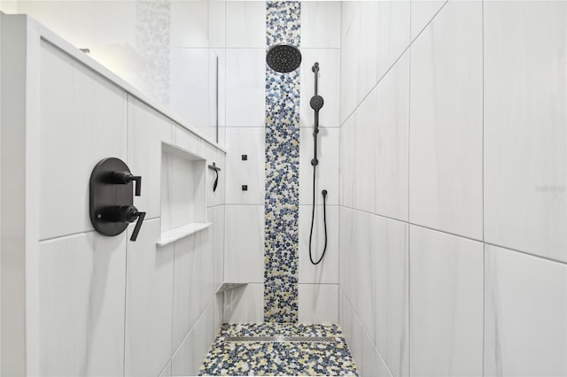 bathroom with a tile shower