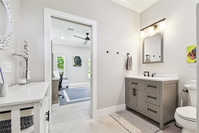 bathroom featuring tile patterned flooring, vanity, ceiling fan, and toilet