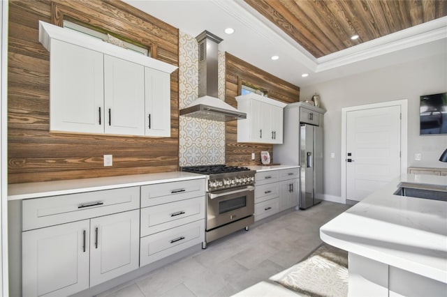 kitchen with wooden ceiling, backsplash, sink, wall chimney exhaust hood, and appliances with stainless steel finishes