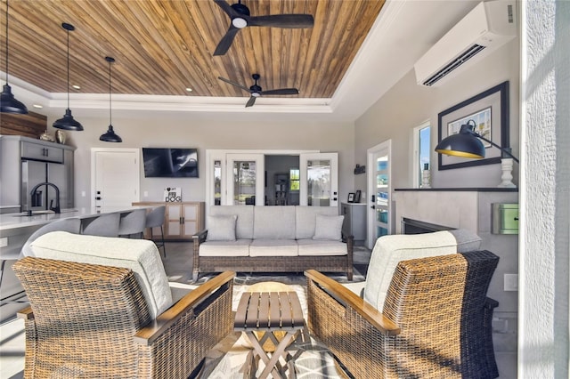 living room featuring a tray ceiling, a wall unit AC, an outdoor fireplace, and wood ceiling