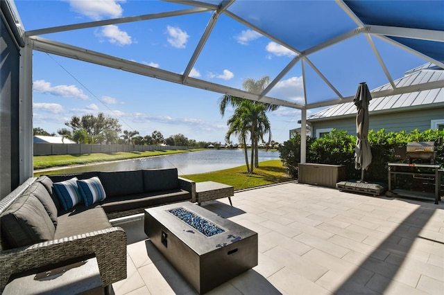 view of patio / terrace with a water view and an outdoor living space with a fire pit