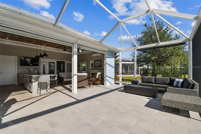 view of patio / terrace featuring outdoor lounge area, a wall mounted air conditioner, a lanai, and a wet bar