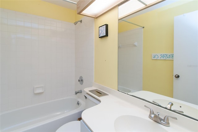 full bathroom with vanity, tiled shower / bath, and toilet