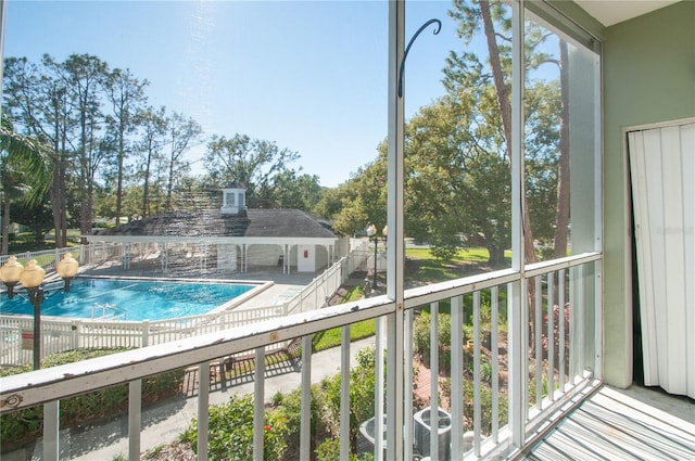 view of pool with cooling unit and a patio