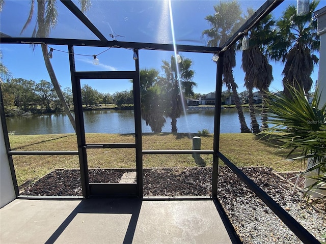 unfurnished sunroom featuring a water view