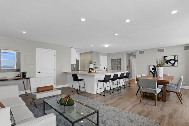 living room featuring hardwood / wood-style flooring and sink