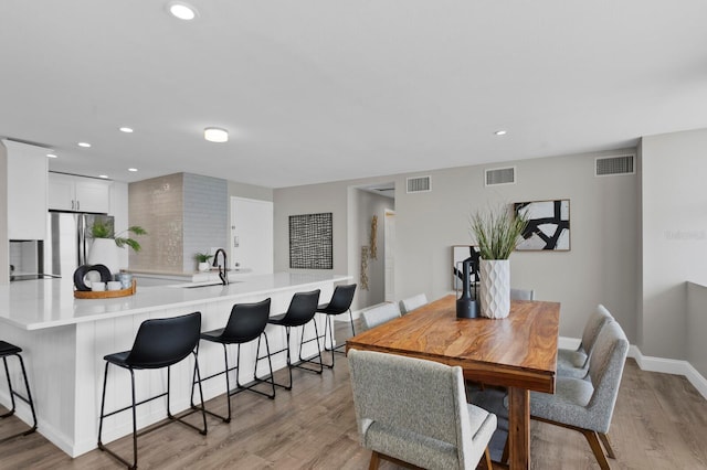 dining room featuring light hardwood / wood-style floors and sink