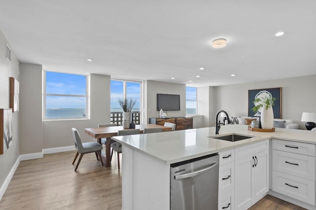 kitchen with dishwasher, light wood-type flooring, white cabinetry, and sink