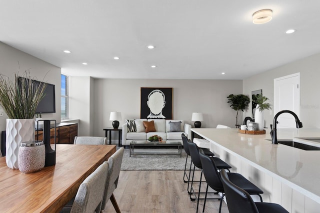 dining area featuring light hardwood / wood-style floors and sink