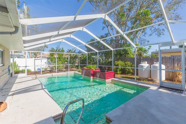 view of pool with a patio and glass enclosure