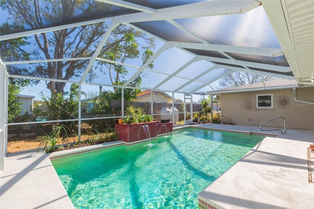 view of swimming pool featuring pool water feature, glass enclosure, and a patio area