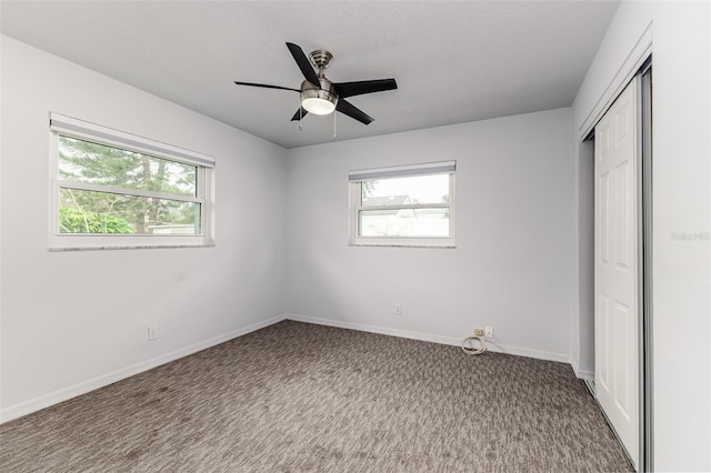 unfurnished bedroom featuring ceiling fan, a closet, carpet, and a textured ceiling