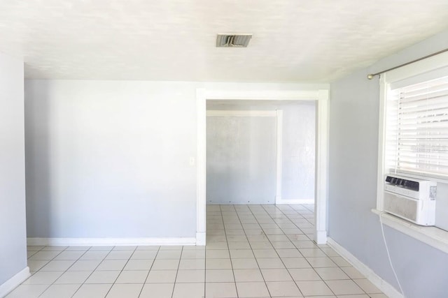 tiled empty room featuring cooling unit