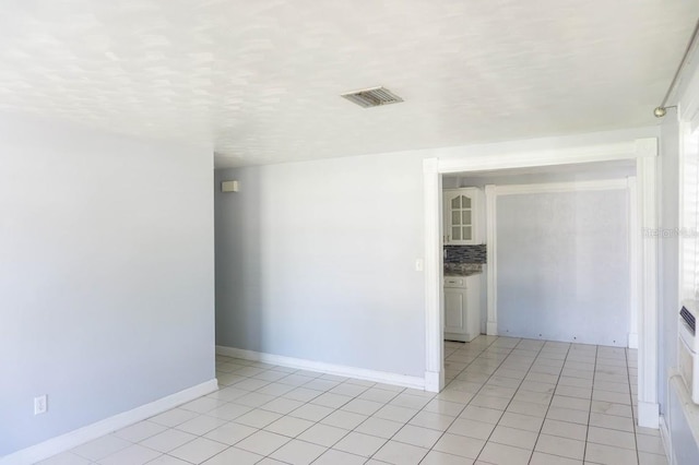 spare room with light tile patterned floors