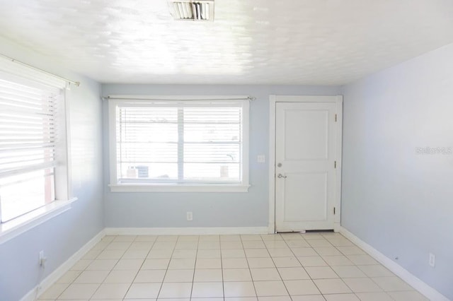 spare room with light tile patterned floors