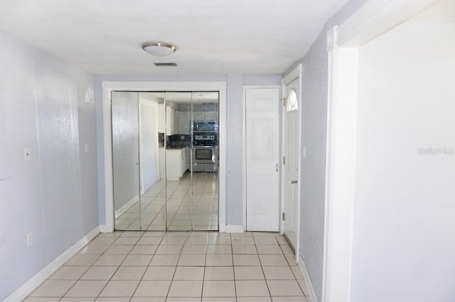 hallway featuring light tile patterned flooring