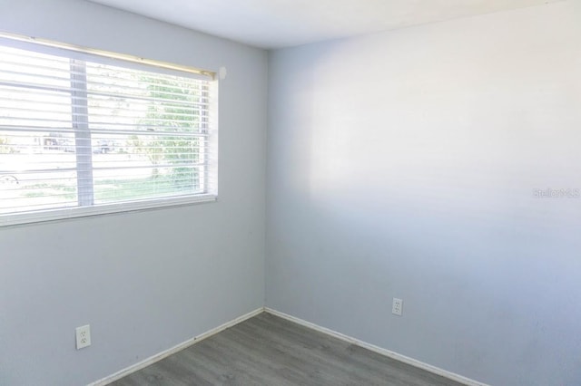 spare room with dark hardwood / wood-style flooring