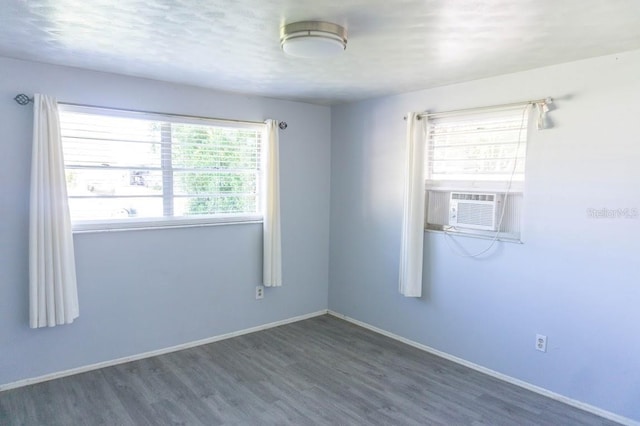 unfurnished room with dark hardwood / wood-style flooring