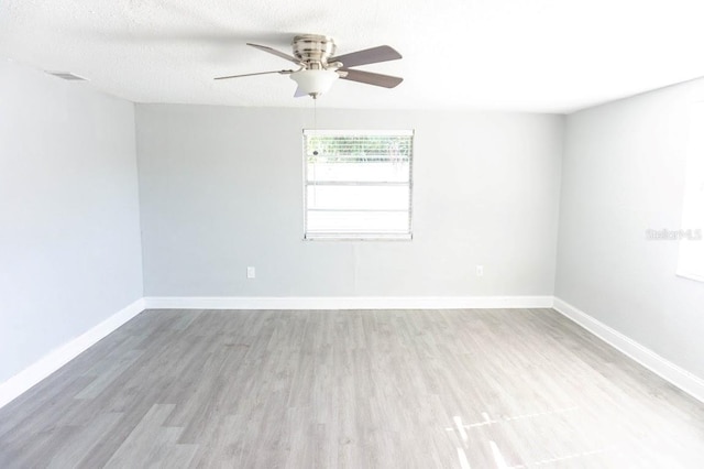 spare room featuring ceiling fan, a textured ceiling, and hardwood / wood-style flooring