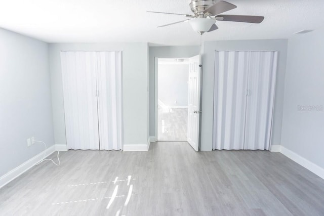 unfurnished bedroom with ceiling fan, light wood-type flooring, and a textured ceiling