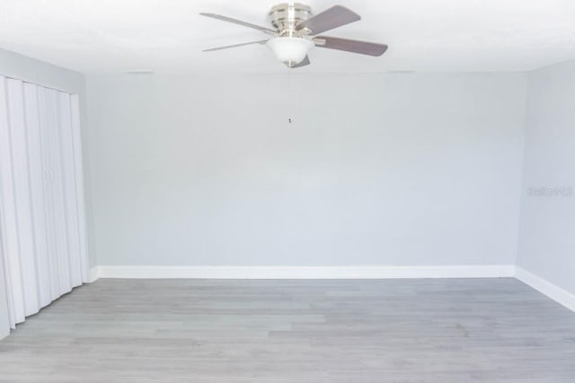 empty room featuring ceiling fan and light hardwood / wood-style floors