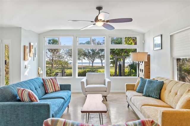 tiled living room featuring a wealth of natural light, lofted ceiling, and ceiling fan