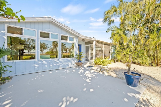 exterior space with a patio and a sunroom