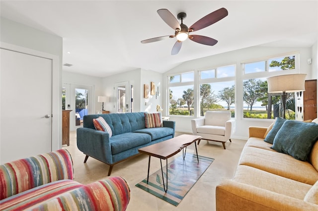 living room featuring ceiling fan, french doors, a healthy amount of sunlight, and vaulted ceiling