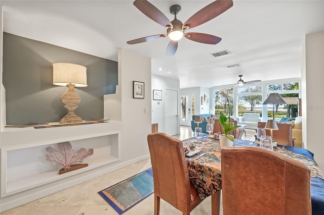 dining area with tile patterned floors and ceiling fan