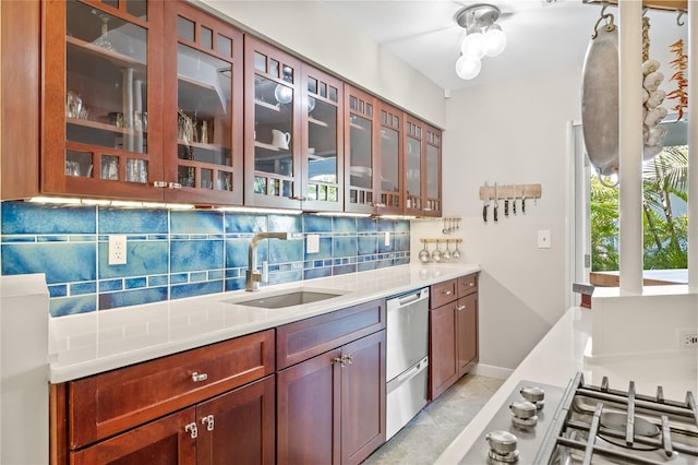 kitchen with decorative backsplash, appliances with stainless steel finishes, and sink