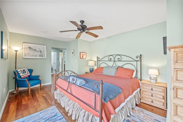 bedroom featuring ceiling fan and dark wood-type flooring