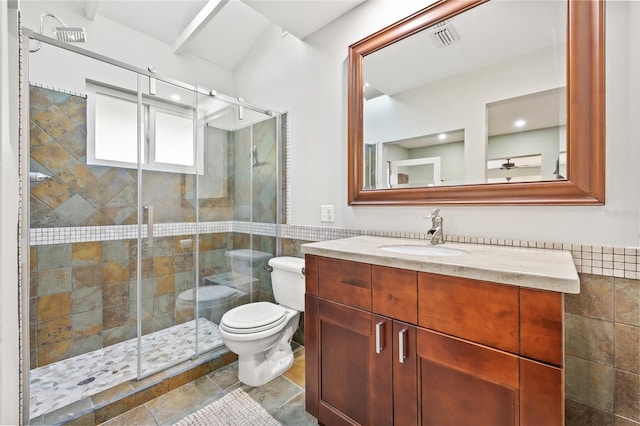 bathroom with toilet, vanity, and walk in shower