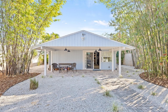 back of property with ceiling fan and a patio area