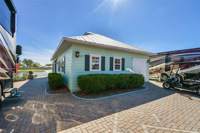 view of property exterior with a water view