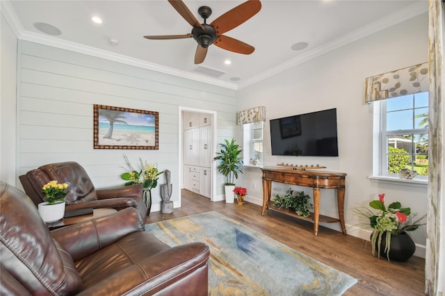 living room featuring ceiling fan, dark wood-type flooring, and ornamental molding