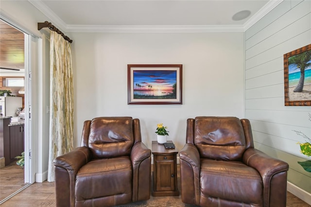 sitting room featuring light wood-type flooring and crown molding