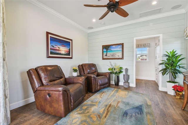 living room with crown molding, ceiling fan, dark wood-type flooring, and wood walls