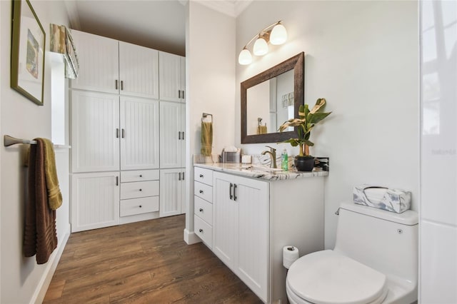 bathroom featuring hardwood / wood-style floors, vanity, and toilet