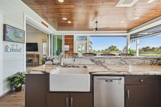 kitchen featuring dark brown cabinetry, stainless steel dishwasher, a wealth of natural light, and sink